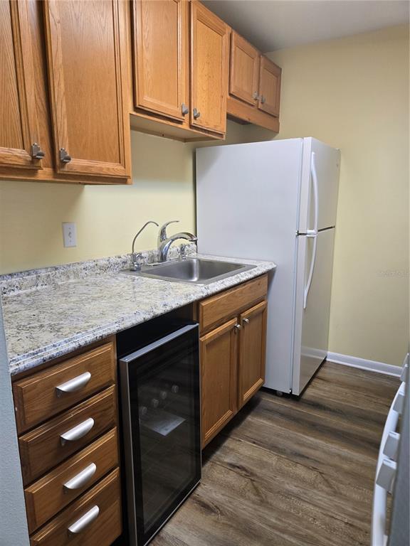 5925 Terrace Park Drive North, Unit 106 St. Petersburg, FL 33709 - Photo 8 of 22 a kitchen with stainless steel appliances granite countertop a sink stove and cabinets