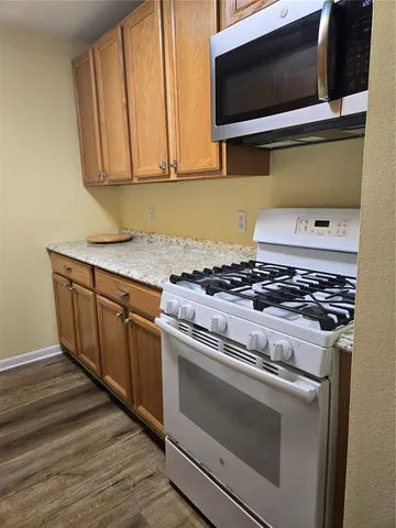 a kitchen with a stove and a microwave