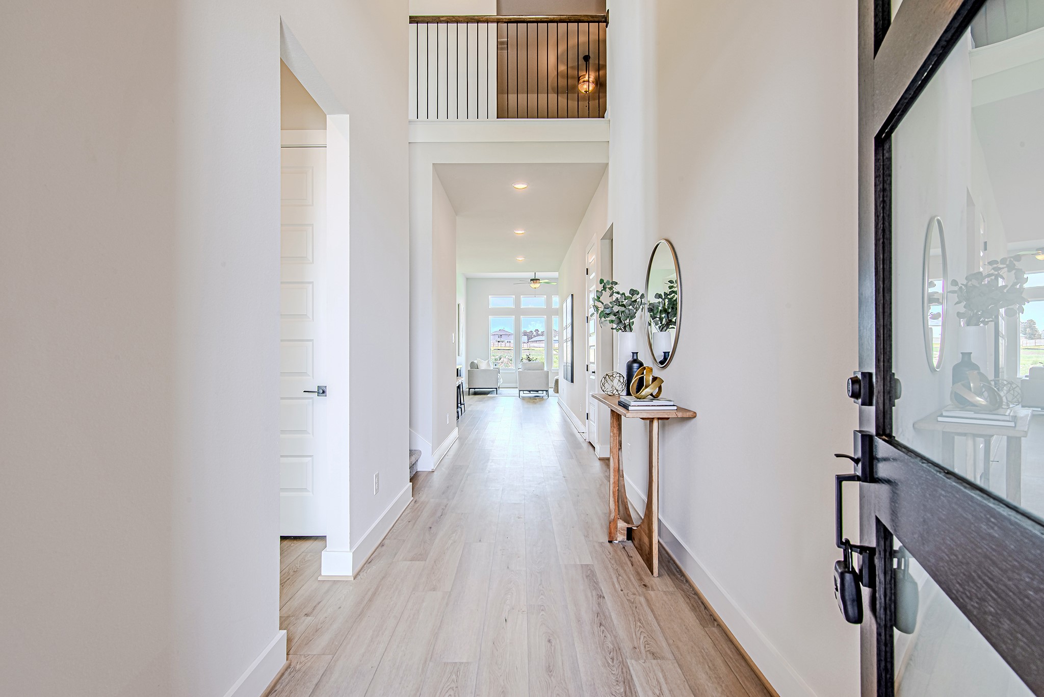 141 Peninsula Point Drive Montgomery, TX 77356 - Photo 7 of 47 Step through the modern glass door into a light-filled entryway with soaring ceilings, clean lines, and a view that draws your eyes straight to the back windows and water beyond.