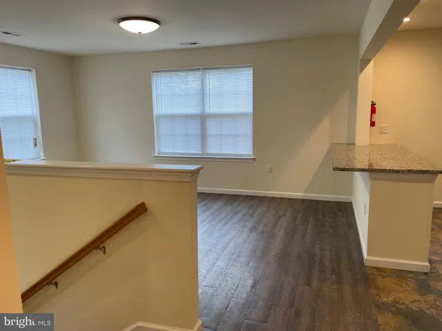 a view of a room with wooden floor and cabinet
