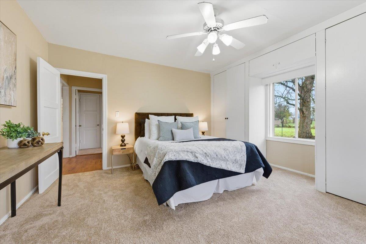 320 West Wise Road Lincoln, CA 95648 - Photo 9 of 28 a bedroom with a bed and a chandelier