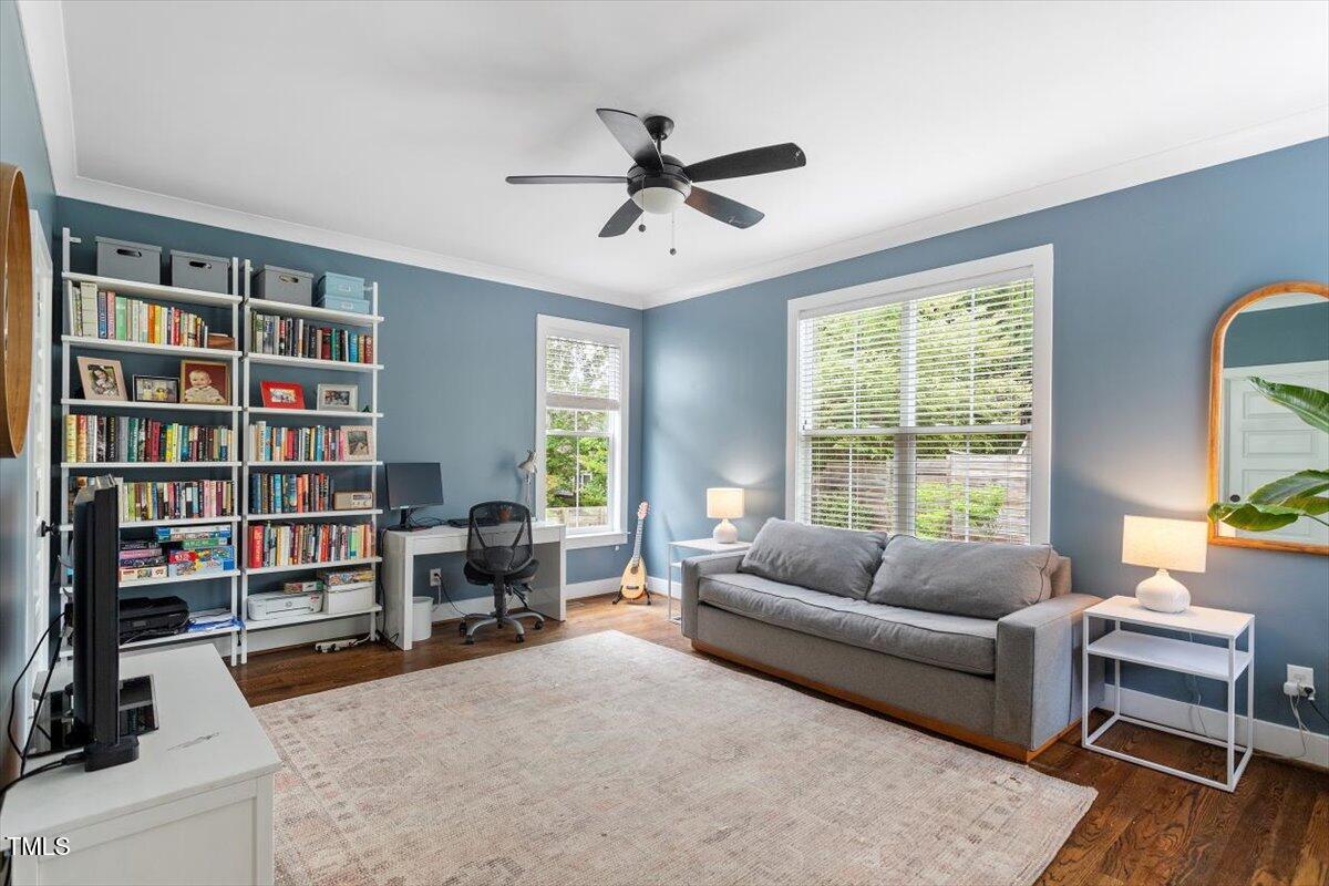 811 East Lane Street Raleigh, NC 27601 - Photo 19 of 35 a living room with furniture and a book shelf