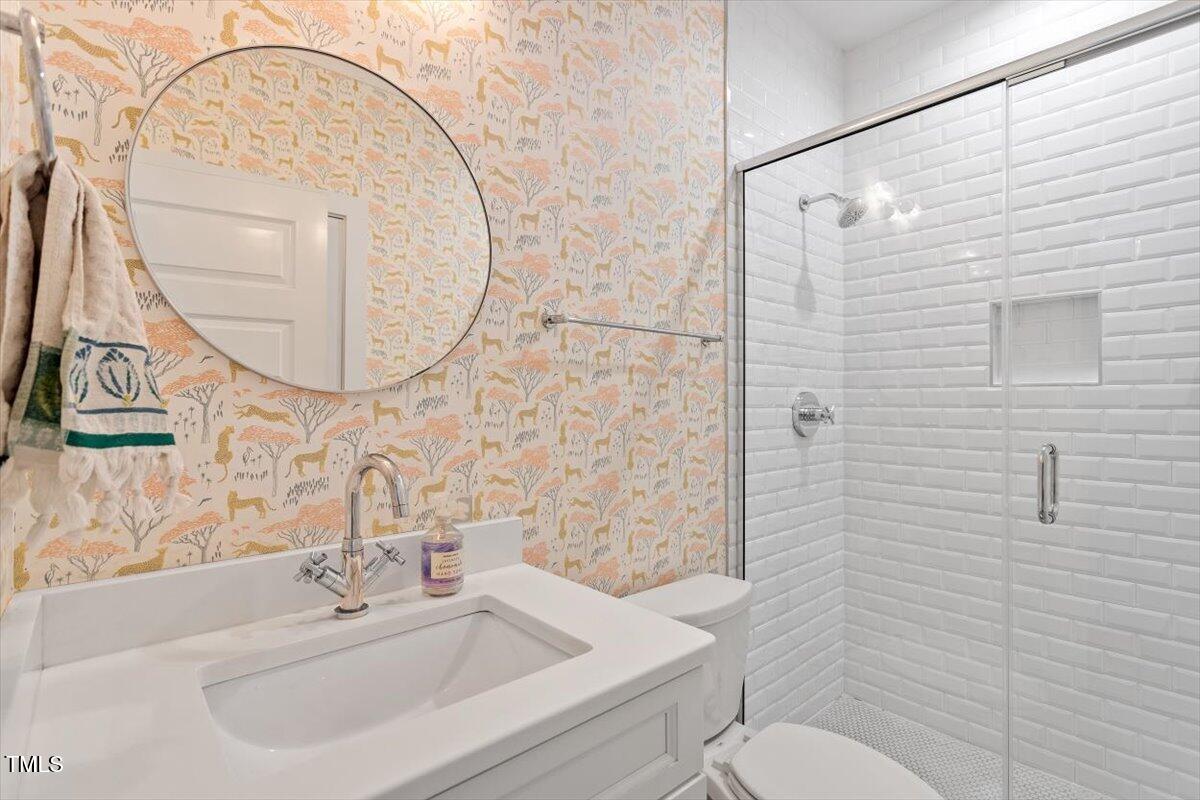 811 East Lane Street Raleigh, NC 27601 - Photo 20 of 35 a bathroom with a sink a toilet and a mirror