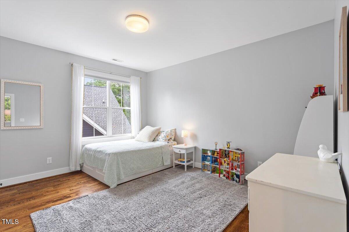 811 East Lane Street Raleigh, NC 27601 - Photo 23 of 35 a room with a bed and a table