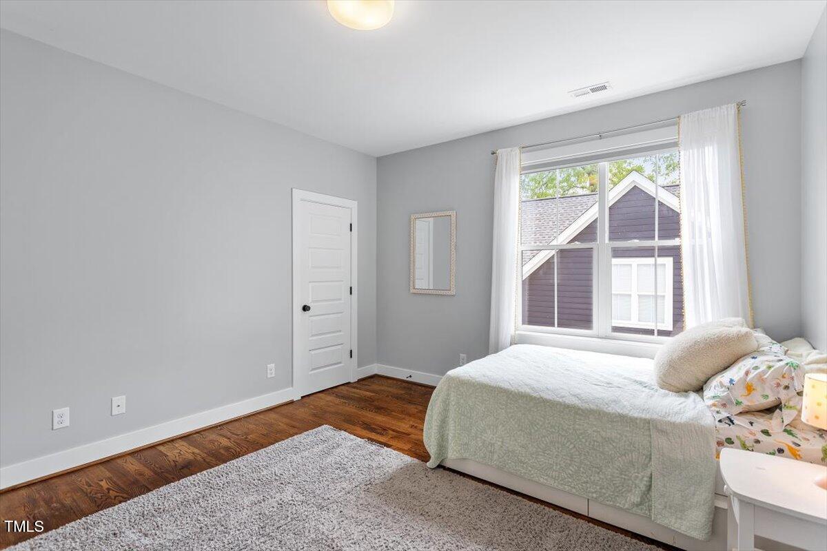 811 East Lane Street Raleigh, NC 27601 - Photo 24 of 35 a bedroom with a bed and a window