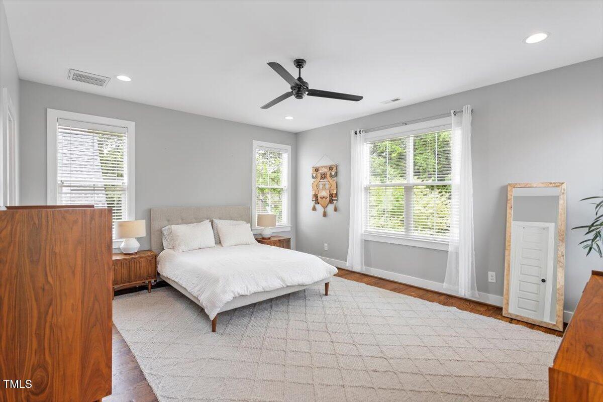 811 East Lane Street Raleigh, NC 27601 - Photo 26 of 35 a bedroom with a bed lamp and a large window