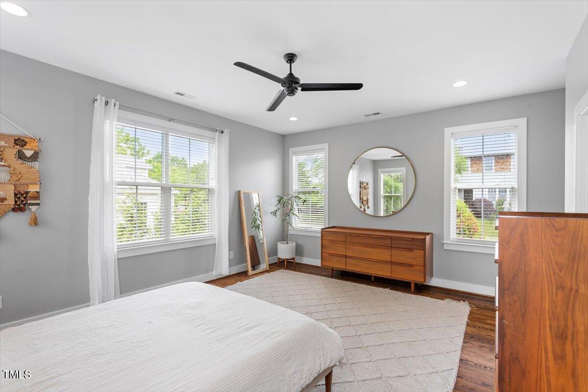 811 East Lane Street Raleigh, NC 27601 - Photo 29 of 35 a bedroom with a bed mirror and window