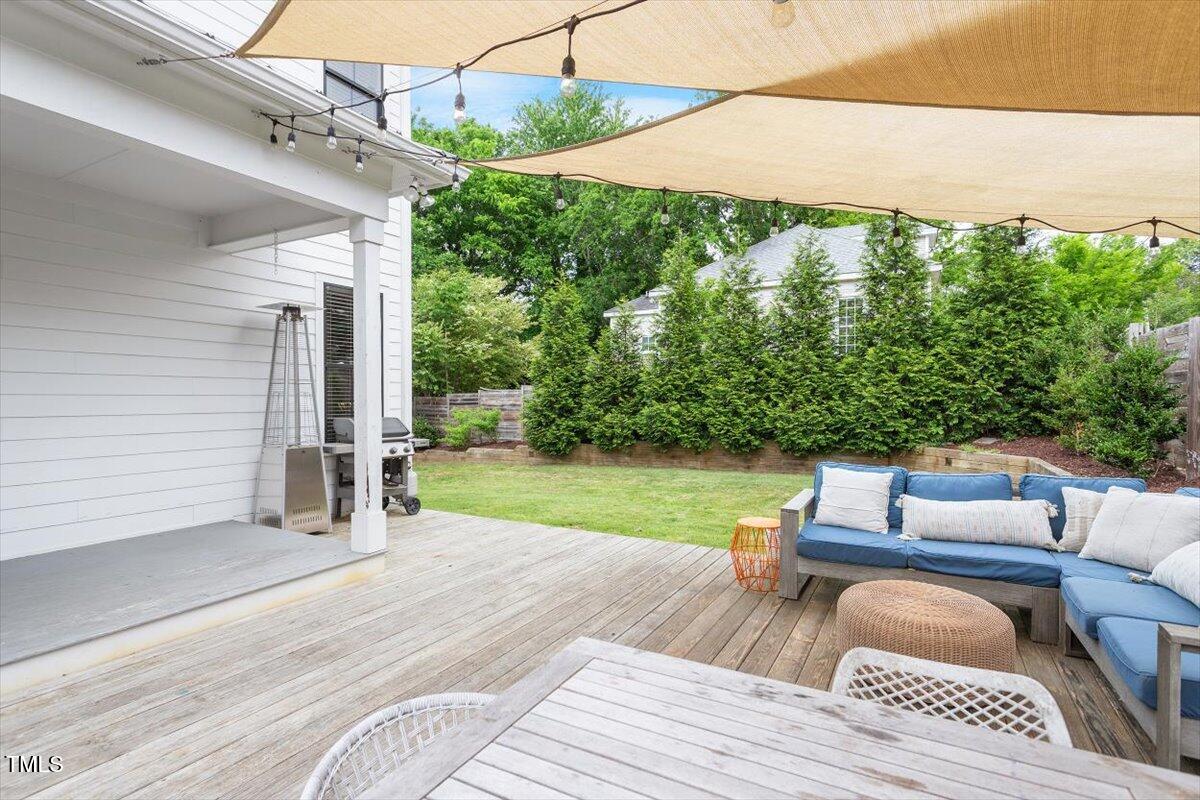 811 East Lane Street Raleigh, NC 27601 - Photo 8 of 35 a view of a patio with couches chairs potted plants and a palm tree