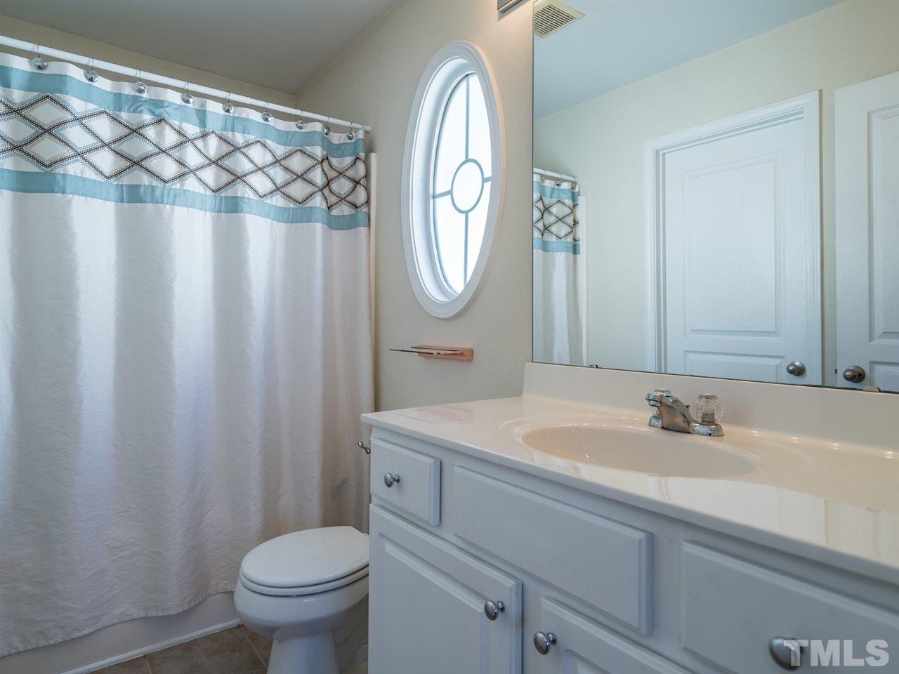 4414 Sugarbend Way Raleigh, NC 27606 - Photo 18 of 24 The master suite has a tub/shower combination and spacious vanity.