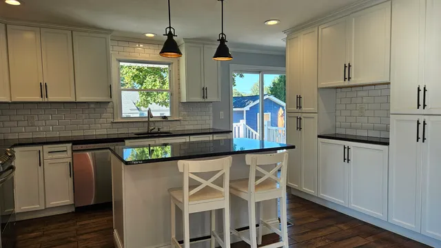 a kitchen with stainless steel appliances granite countertop a sink and a microwave