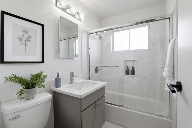 a bathroom with a sink toilet and shower