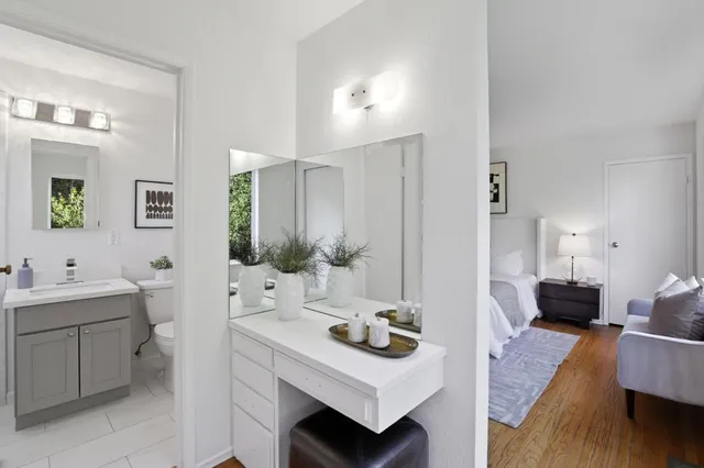 a spacious bathroom with a sink double vanity granite and a mirror