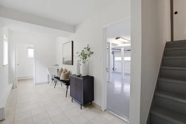 a view of a livingroom with furniture and an entryway
