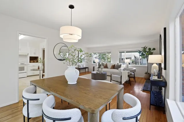 a view of a dining room with furniture and wooden floor