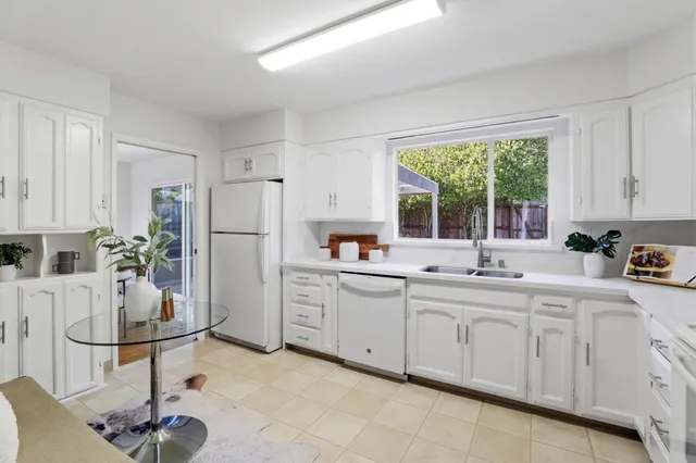 a kitchen with appliances cabinets and a sink