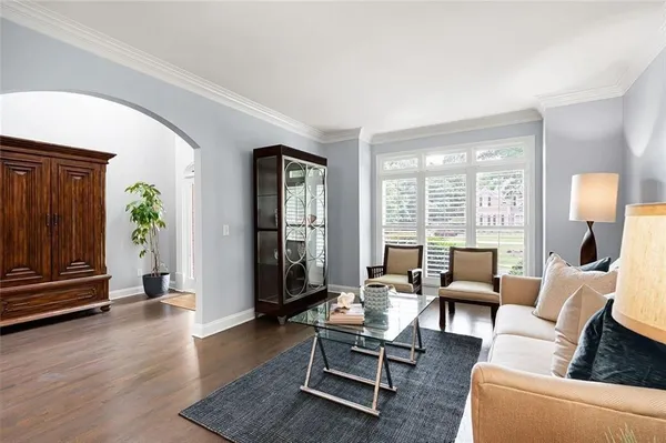 a living room with furniture a fireplace and a floor to ceiling window