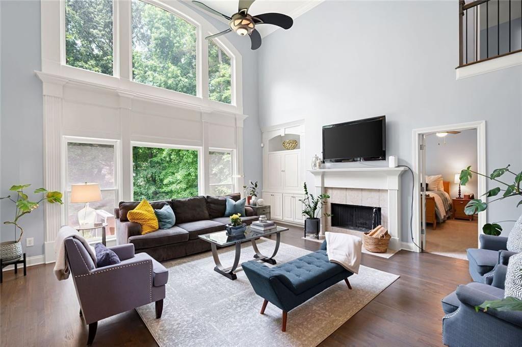 3045 Moss Stone Lane Southwest Marietta, GA 30064 - Photo 12 of 65 a living room with furniture a fireplace and a floor to ceiling window