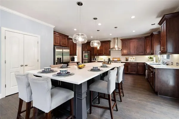 a kitchen with a stove a sink and a refrigerator