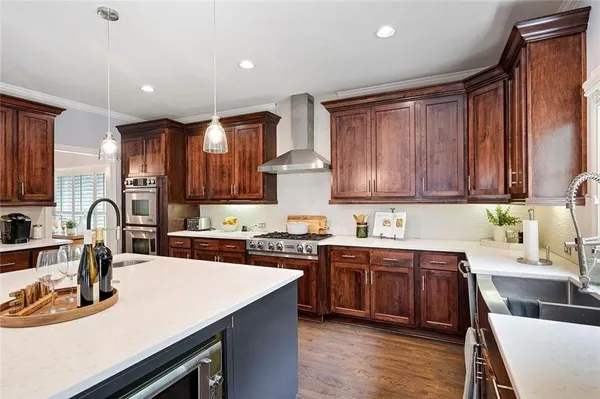 a kitchen with a sink stove top oven and cabinets