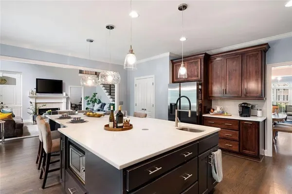 a kitchen with stainless steel appliances granite countertop a stove and a wooden cabinets