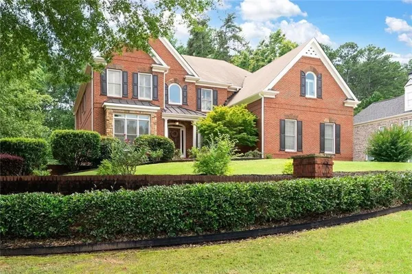 a front view of a house with a yard