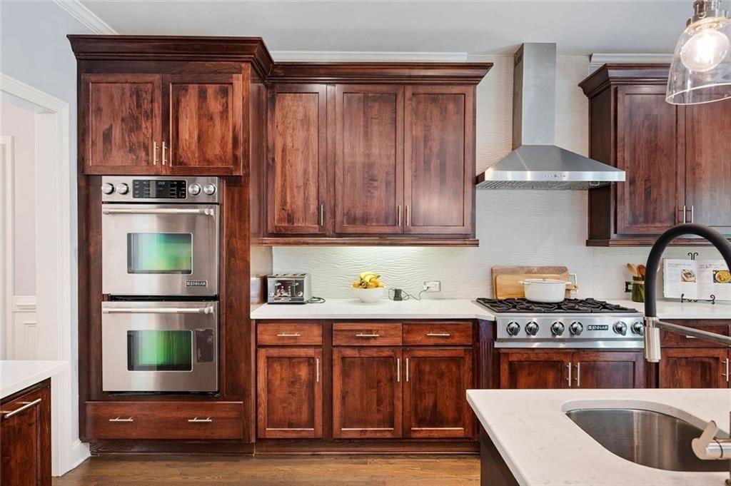 3045 Moss Stone Lane Southwest Marietta, GA 30064 - Photo 21 of 65 a kitchen with stainless steel appliances granite countertop a stove and a wooden cabinets