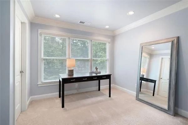 a view of a bedroom with workspace and a window