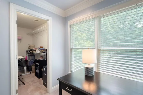 a bedroom with a bed and a desk