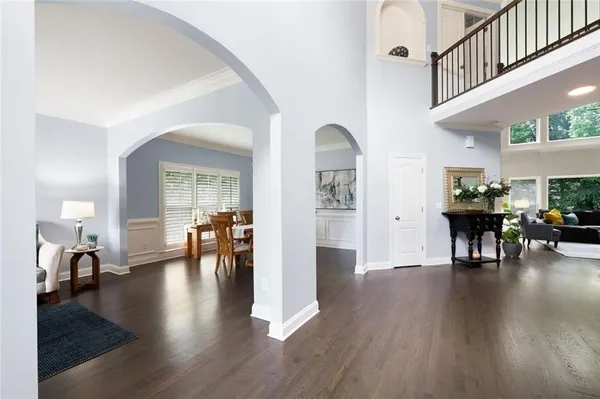 a dining room with furniture a chandelier and wooden floor