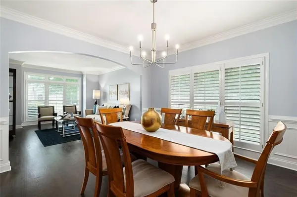 a living room with furniture wooden floor and a large window