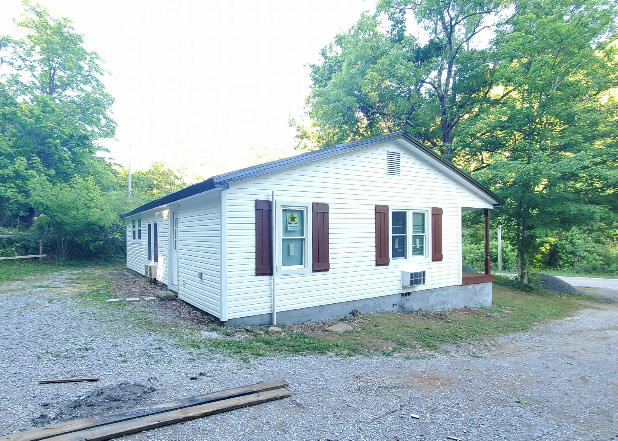 210 Rawls Creek Road Gordonsville, TN 38563 - Photo 5 of 13 a front view of a house with a yard and garage