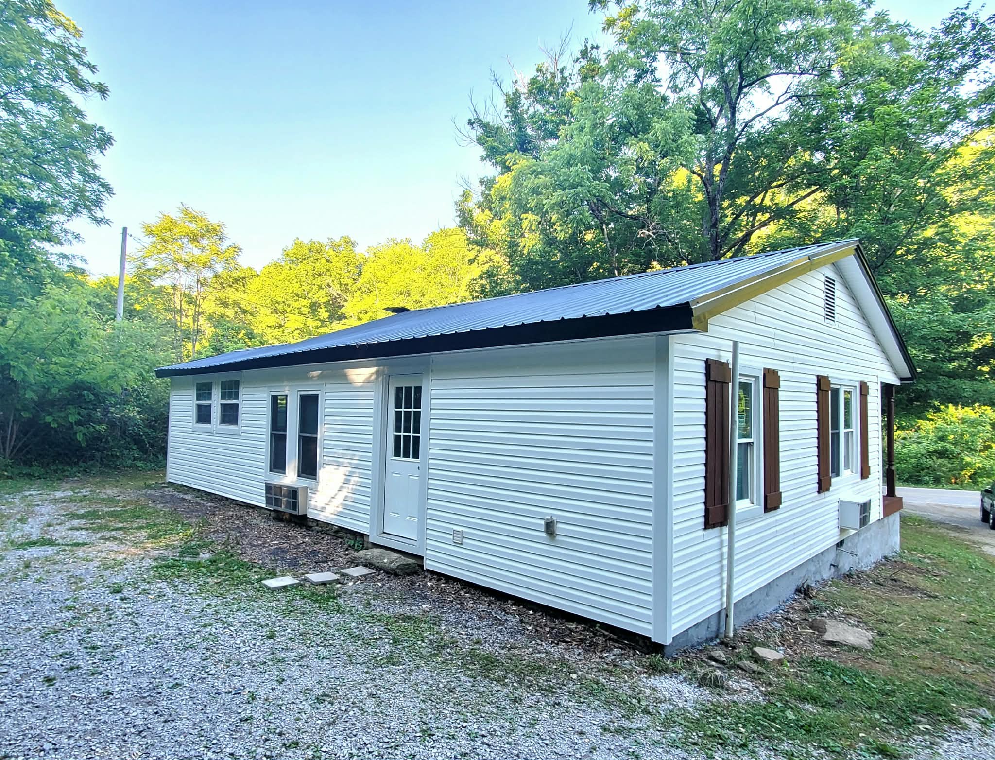 210 Rawls Creek Road Gordonsville, TN 38563 - Photo 6 of 13 a view of a small house with a yard