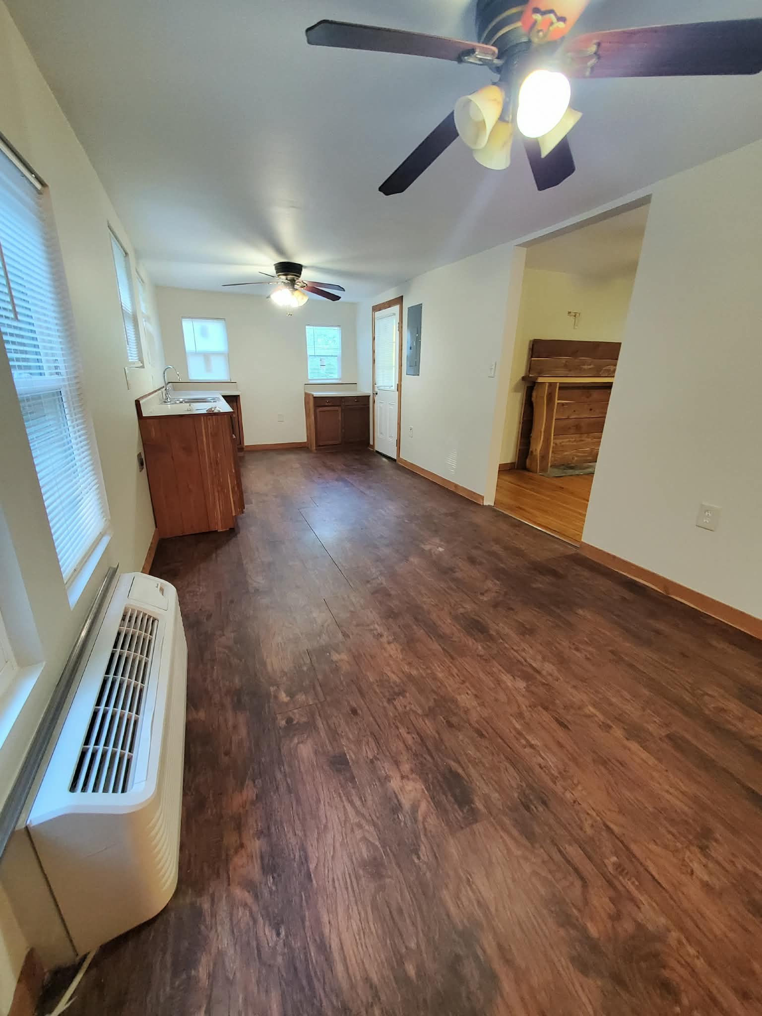 210 Rawls Creek Road Gordonsville, TN 38563 - Photo 8 of 13 a view of an empty room and chandelier fan wooden floor and a window