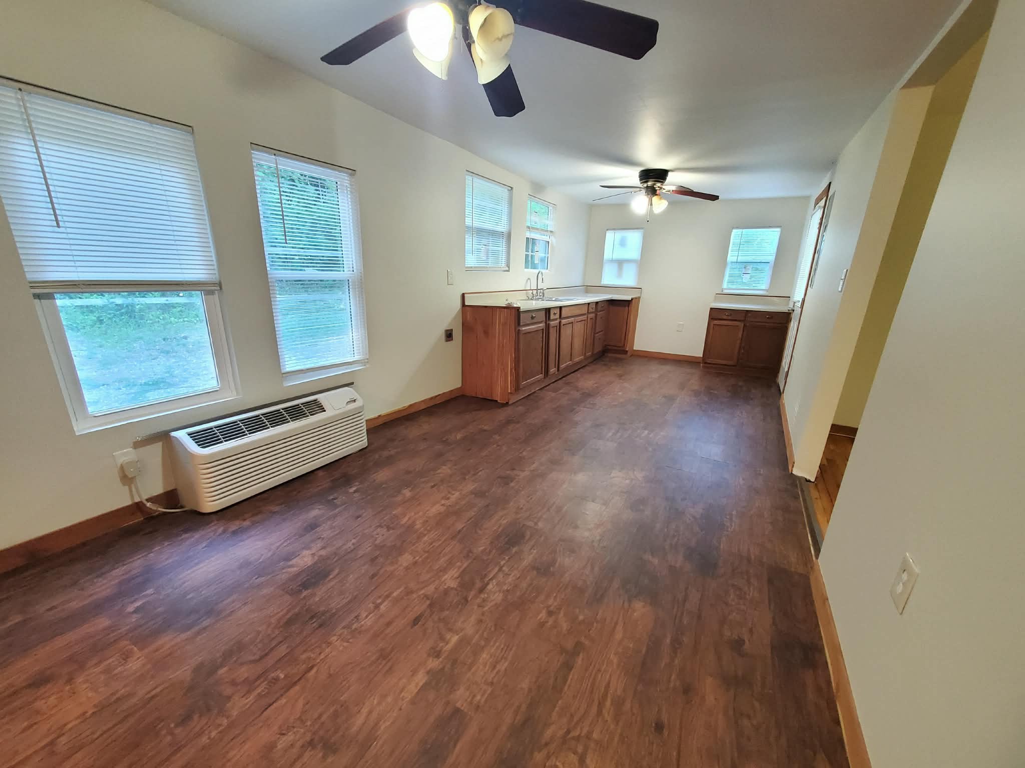 210 Rawls Creek Road Gordonsville, TN 38563 - Photo 9 of 13 wooden floor in an empty room with a window