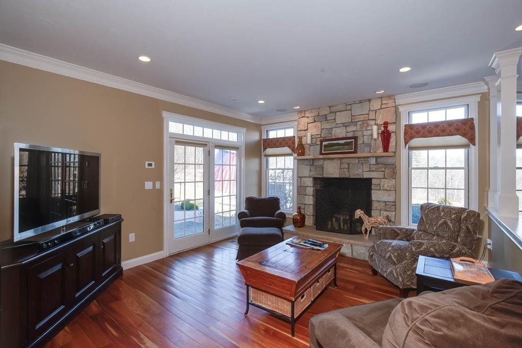 121 Douglas Road Sutton, MA 01590 - Photo 14 of 42 a living room with furniture a flat screen tv and a fireplace