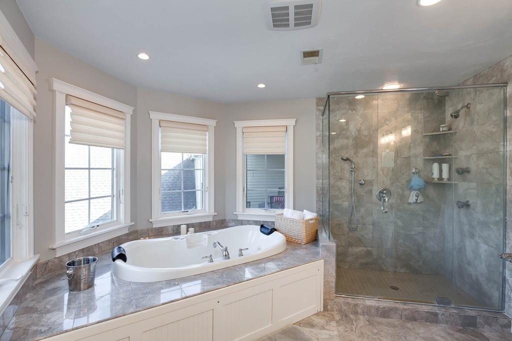 121 Douglas Road Sutton, MA 01590 - Photo 22 of 42 a bathroom with a granite countertop bathtub shower sink and mirror