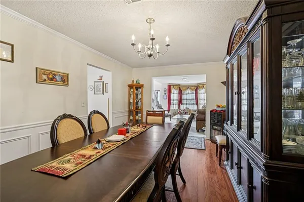 a dining room with furniture a rug and wooden floor