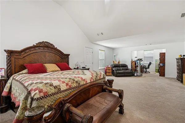 a bedroom with a bed and lamp