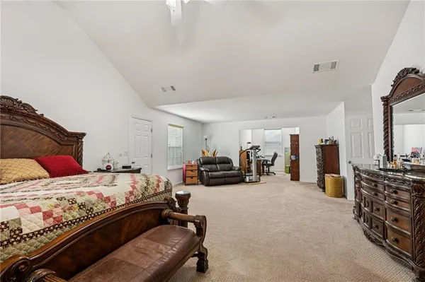 a bedroom with furniture and a large window
