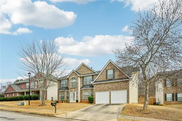 a front view of a house with a yard