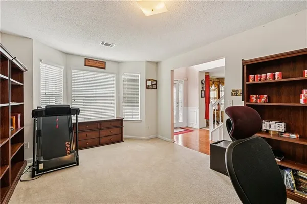 a livingroom with workspace and a window