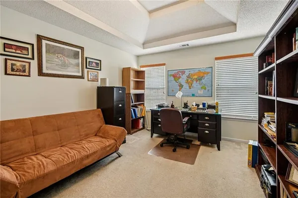 a livingroom with workspace and a couch