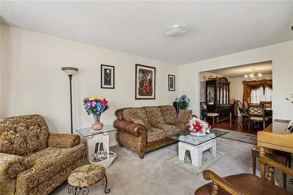 a living room with furniture chess board and a window