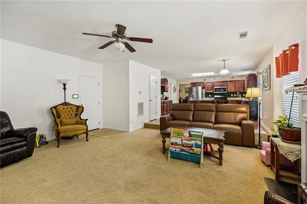 a living room with furniture and a chandelier