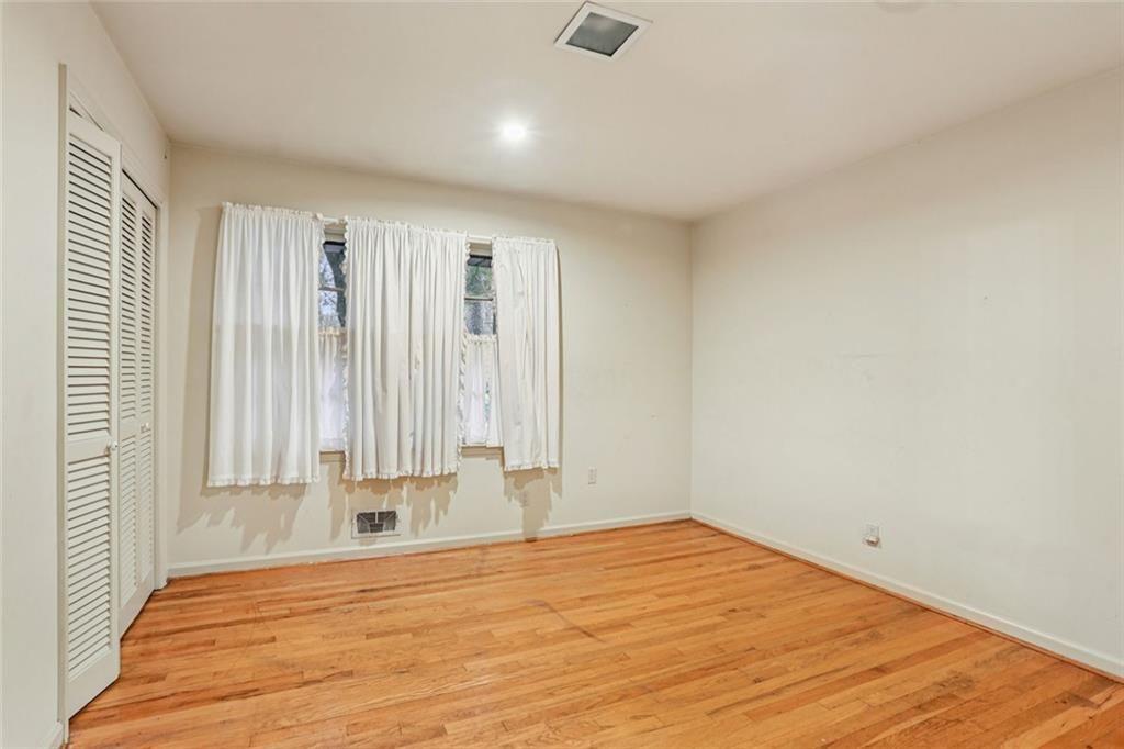 6300 East Stubbs Road Atlanta, GA 30349 - Photo 12 of 29 a view of empty room with wooden floor and fan