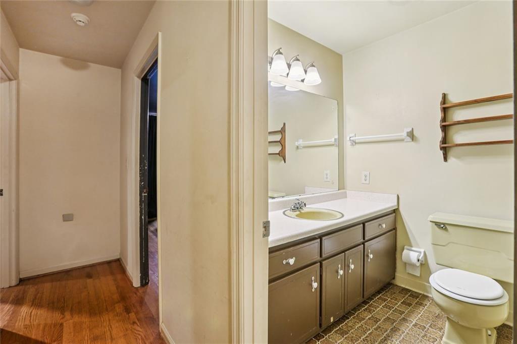 6300 East Stubbs Road Atlanta, GA 30349 - Photo 13 of 29 a bathroom with a granite countertop sink toilet and shower