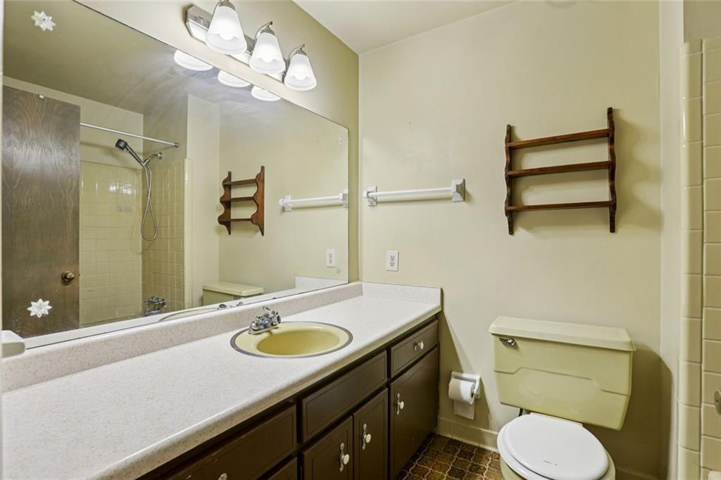 6300 East Stubbs Road Atlanta, GA 30349 - Photo 14 of 29 a bathroom with a sink a toilet and shower