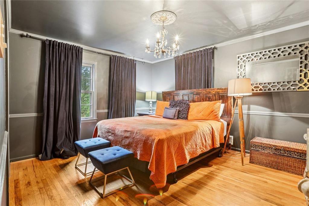 6300 East Stubbs Road Atlanta, GA 30349 - Photo 15 of 29 a bedroom with a bed and a chandelier