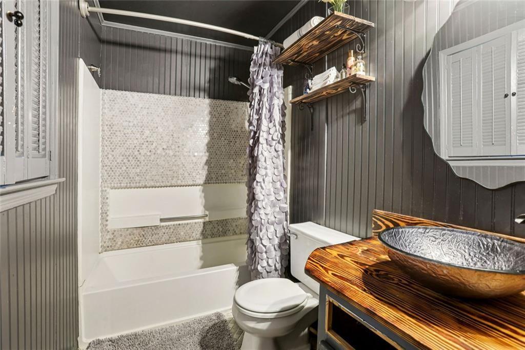 6300 East Stubbs Road Atlanta, GA 30349 - Photo 18 of 29 a bathroom with a granite countertop bathtub shower sink vanity and toilet