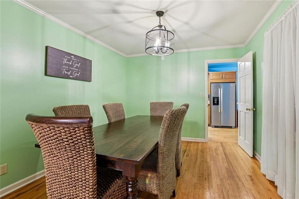 6300 East Stubbs Road Atlanta, GA 30349 - Photo 6 of 29 a view of a dining room with furniture and wooden floor